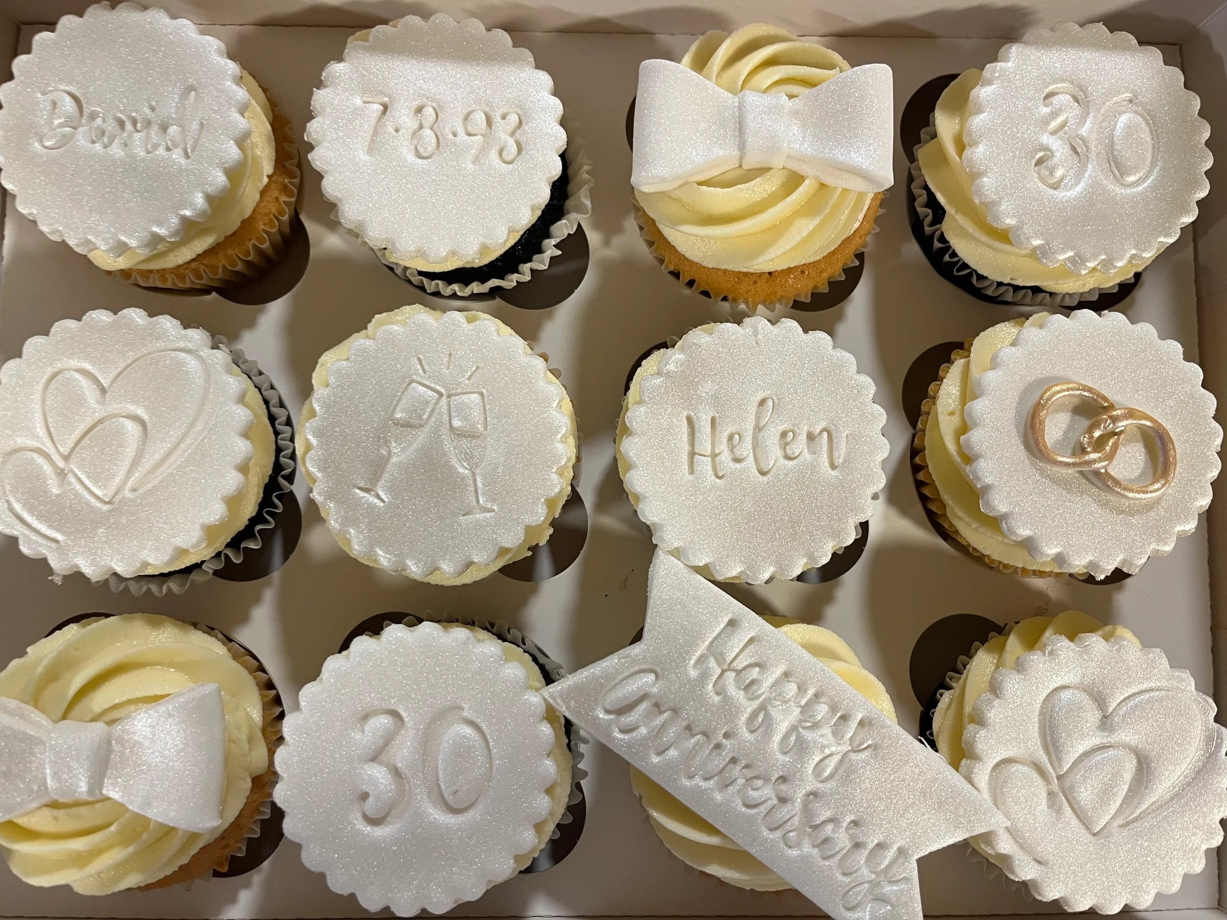 White anniversary cupcakes with dates